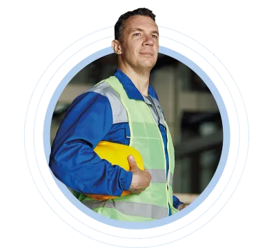 Worker in high-visibility gear holding a hard hat